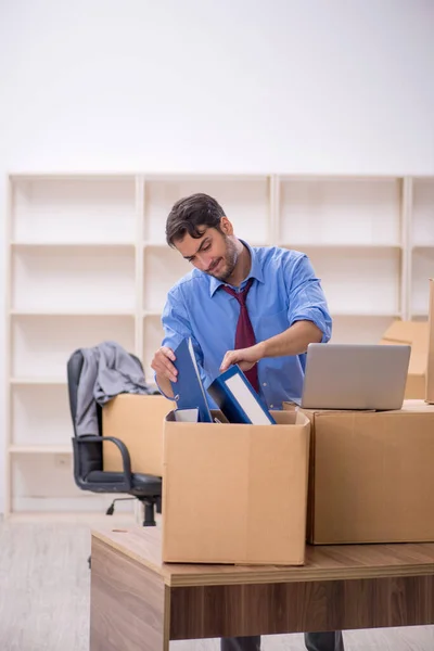 Young businessman employee in office relocation concept