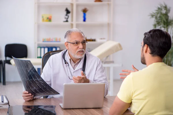 Young doctor visiting old doctor radiologist