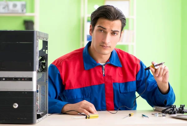 The computer engineer repairing broken desktop