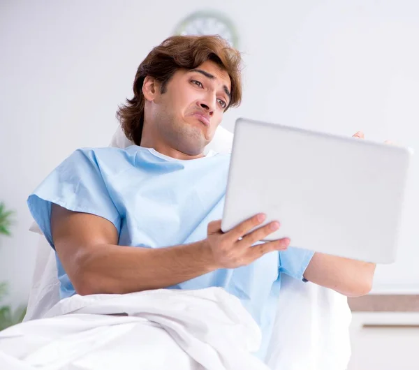 The young male patient lying on couch in hospital