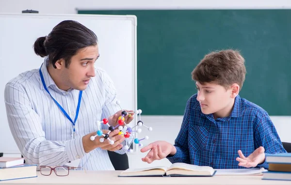 Young Male Teacher Explaining Molecular Model — ストック写真