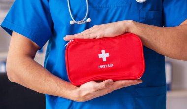 The male doctor with first aid bag