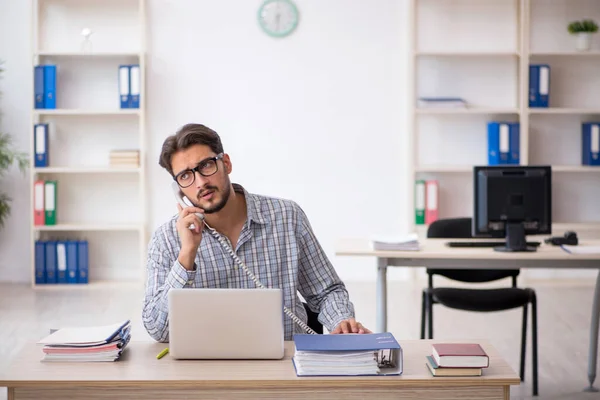 stock image Young male employee sitting at workplace