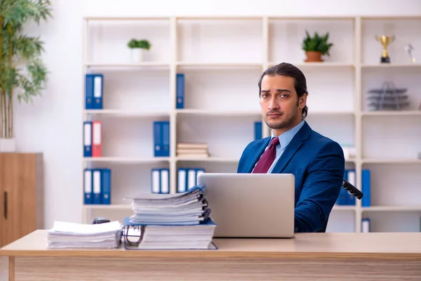 Young male disabled employee working in the office