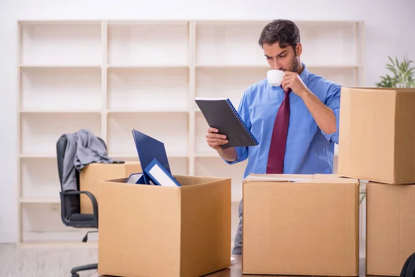 Young businessman employee in office relocation concept