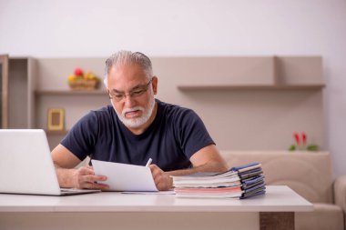 Yaşlı adam salgın sırasında evden çalışıyor.