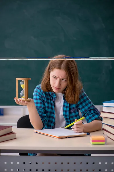 Young girl student in time management concept