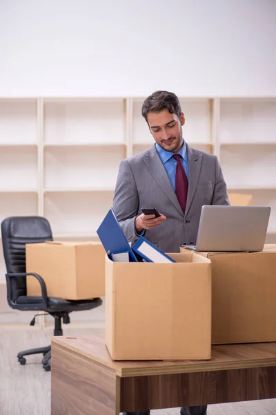Young businessman employee in office relocation concept