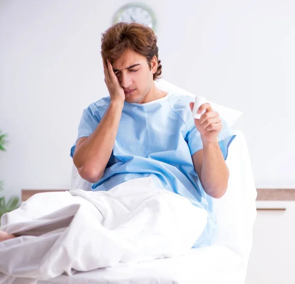 The young male patient lying on couch in hospital