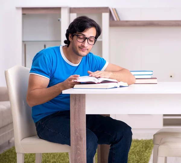 The young handsome student studying at home