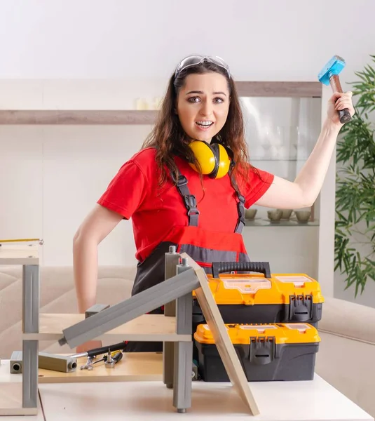 The female contractor repairing furniture at home