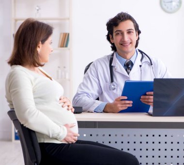 The old pregnant woman visiting young male doctor