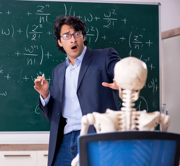 The young male math teacher and student skeleton