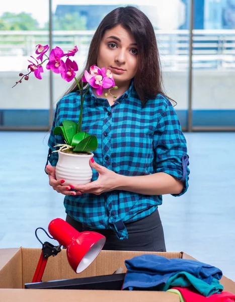 The young woman moving personal belongings