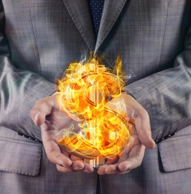 Yanan Amerikan Doları işareti tutan iş adamı.