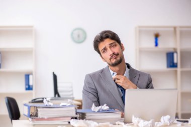 Genç bir çalışan ve ofiste çok fazla iş var.
