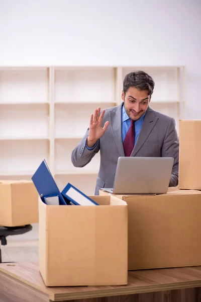 Young businessman employee in office relocation concept