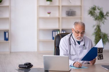 Hastanede çalışan yaşlı bir radyoloji uzmanı.