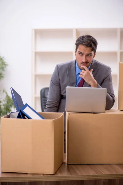 Young businessman employee in office relocation concept