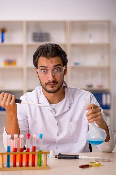 Young chemist working at the lab