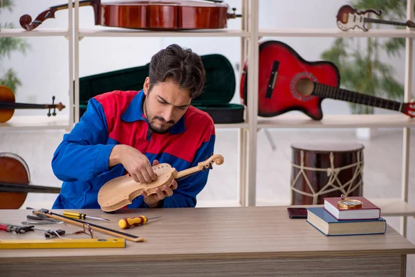 Young Man Repairing Musical Instruments Indoors — Stock Photo, Image