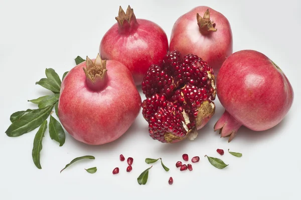 Ripe fresh pomegranates wth leaves — Stock Photo, Image