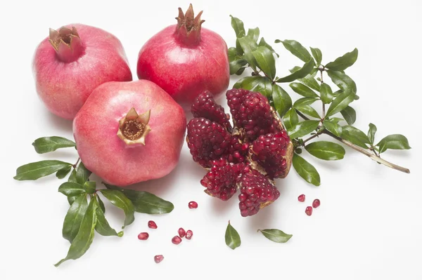 Ripe fresh pomegranates wth leaves — Stock Photo, Image