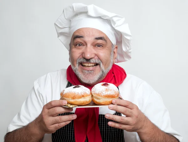 Smiling chef with Hanukkah doughnuts — Stock Photo, Image