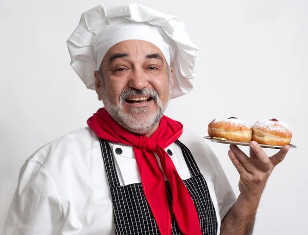 Smiling chef with Hanukkah doughnuts — Stock Photo, Image