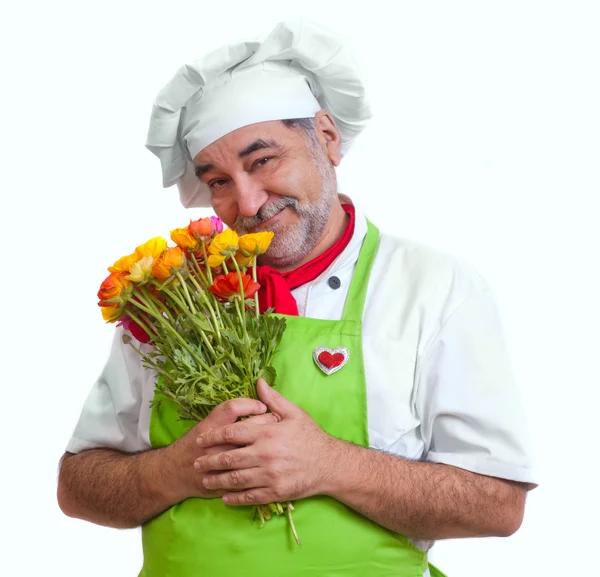 Uśmiechający się atrakcyjny szef kuchni z kwiatami — Zdjęcie stockowe