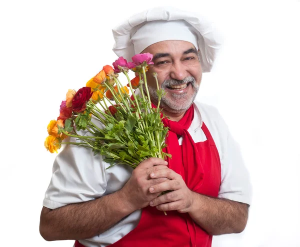 Sorrindo chef atraente com flores — Fotografia de Stock