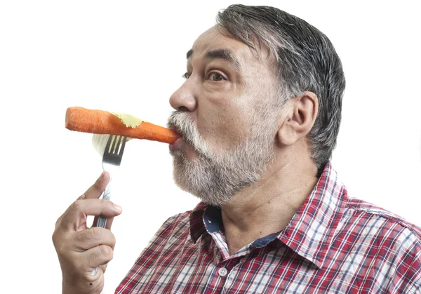 Man eating carrot — Stock Photo, Image