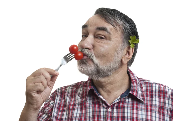 Man eating fresh tomatoes — Stock Photo, Image