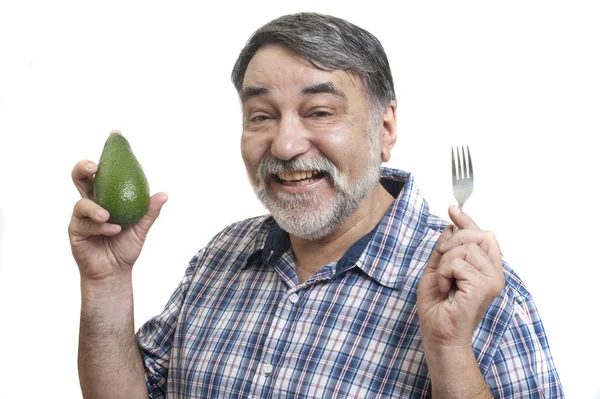 Mann isst Avocado — Stockfoto