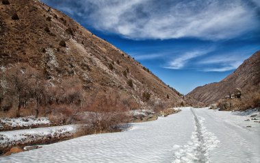Volumetric landscape of mountains. Snowy trail