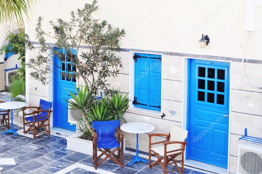 Greek traditional white walls and blue door in one of the small villages, Cyclades, Greece