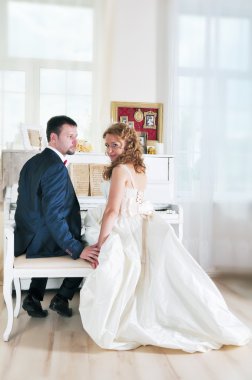 Piyanonun yanında mutlu evli çift