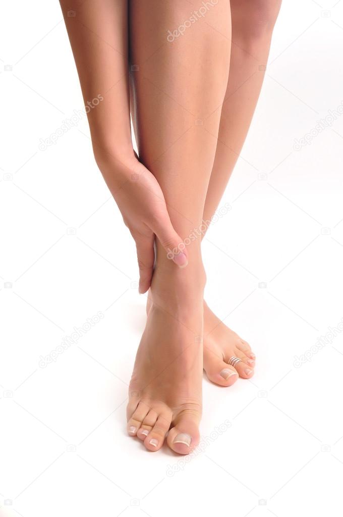 Girl massages the thin and long tired feet