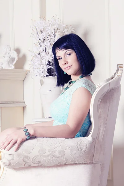 Young woman sitting on the armchair — Stock Photo, Image