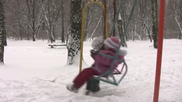 Children on winter seesaw — Stock Video