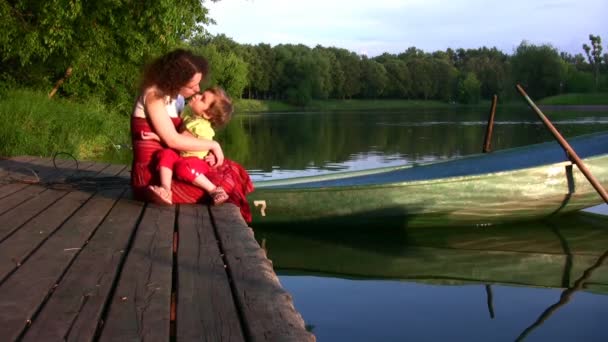 Mère avec fille sur l'étang près du bateau — Video