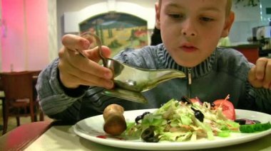Boy with sauce, bread, salad
