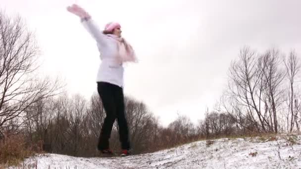 Frau tanzt auf schneebedeckter Wiese. — Stockvideo