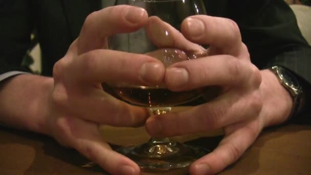 Fingers on cognac glass — Stock Video