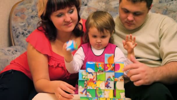 Daughter with parents playing cubes — Stock Video