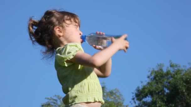 Girl drinks water from bottle and smiles — Stock Video