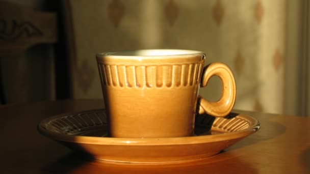 Cup with hot coffee on saucer. Time lapse. Moving shadow — Stock Video