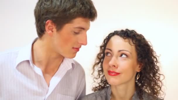 Couple on the white background looking at each other smiling and laughing — Stock Video