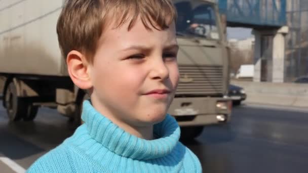 Boy on road peers into distance — Stock Video