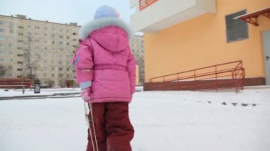 kamera üzerinde kar kızağı taşıyan küçük bir kız